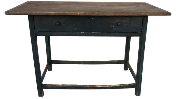 E465 Mid 18th Century New England stretcher base Tavern Table with dovetailed drawer. Two board top is secured to the base with wooden pegs. Breadboard ends on the top are held in place with rose head nails. Top rests on a Birch base with reeded legs and chamfered inner corners. Stretchers are all original and show great wear indicative of its age. Table retains the original surface. The paint is a 19th century blue over the original 18th century grey paint. A fine example of New England Tavern tables. Measurements: 26 1/2” wide x 43 3/4” long x 27” tall