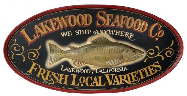 F151 Early 20th century beautiful wooden Double Sided Seafood Co. Hanging Wood Advertising Sign. Large oval double sided sign centered with a relief carved fish and reads "Lakewood Seafood Co., We Ship Anywhere, Fresh Local Varieties, Lakewood, California". Very nice overall condition