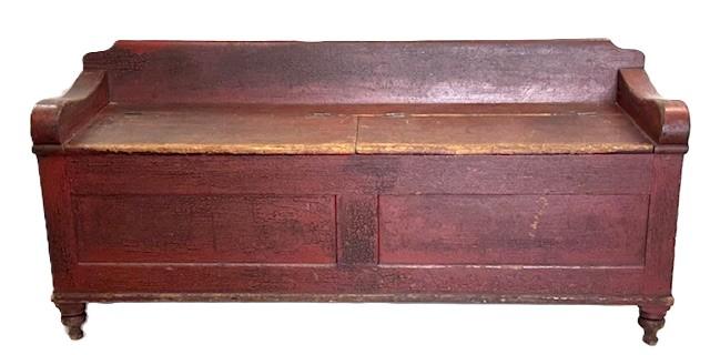 **SOLD** M126 18th century Lancaster County, Pennsylvania Wood box / Settee with divided lift top in original red painted surface. Post and Paneled construction with a dovetailed divided interior. Posts end in round turnings creating the feet. T and square head nail construction. The numbers 54-34-55 and 531 are painted in white on one arm / top of back. We are unsure if these were Museum numbers or for insurance purposes at some point in time. Measurements: 63 3/8 wide x 19 deep x 28 ¾ tall (back) x 21 ½ tall (front). The arms are 2 ¾ wide.